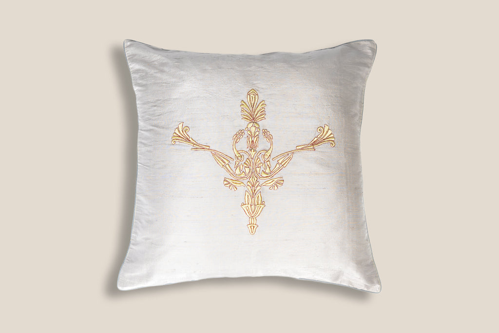 Front of an Exclusive white silk cushion with golden peacock zardozi embroidery