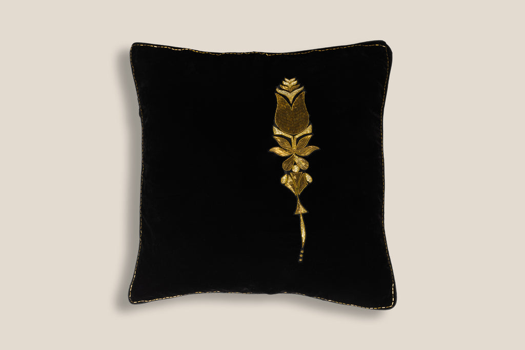 front of an exclusive velvet cushion with golden kad dana flower embroidery 