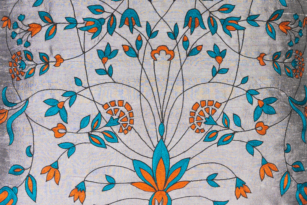 detail of a Exclusive handwoven grey silk with floral turquoise and orange hand work