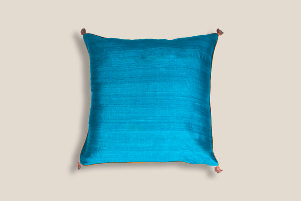 front of an exclusive ocean silk cushion with  tassels