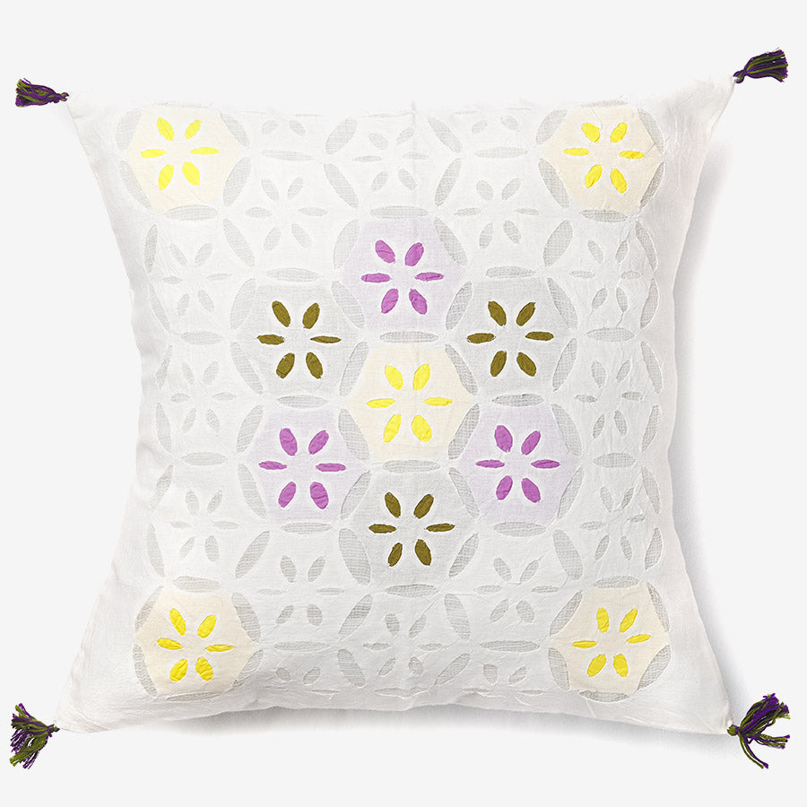 front of a white luxury cushion cover with multicolour leaves